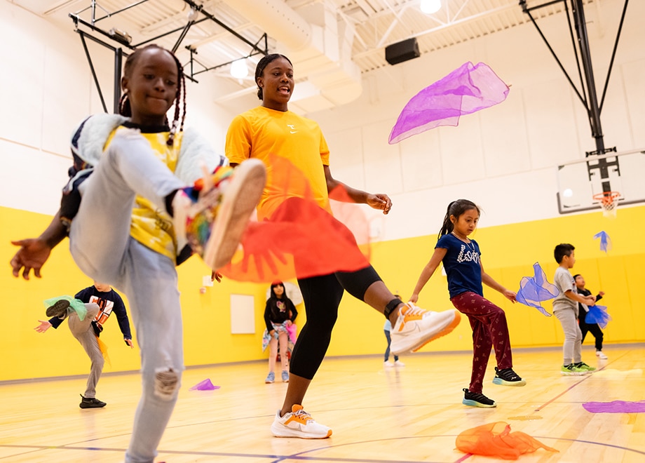 Young students participate in an activity in a gymnasium