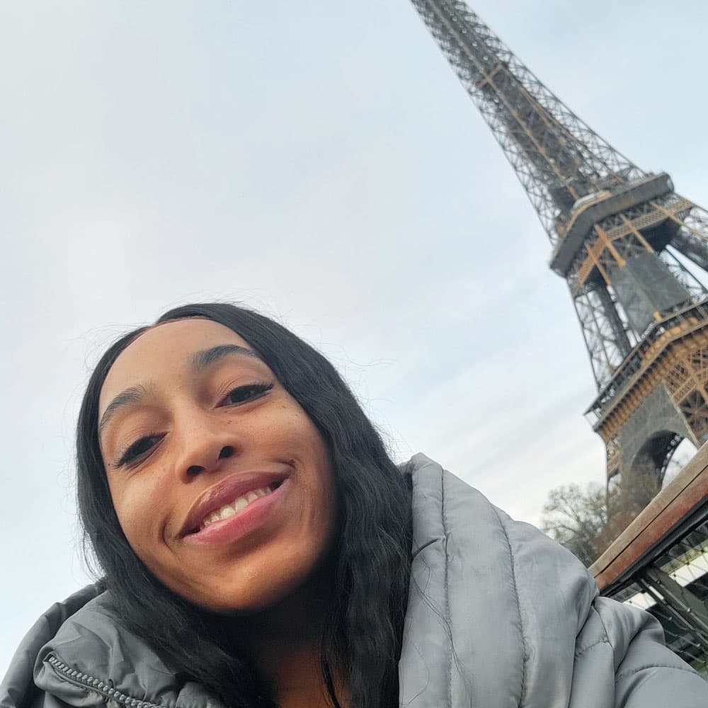 Azaria Boyd takes a selfie with the Eiffel Tower in the background