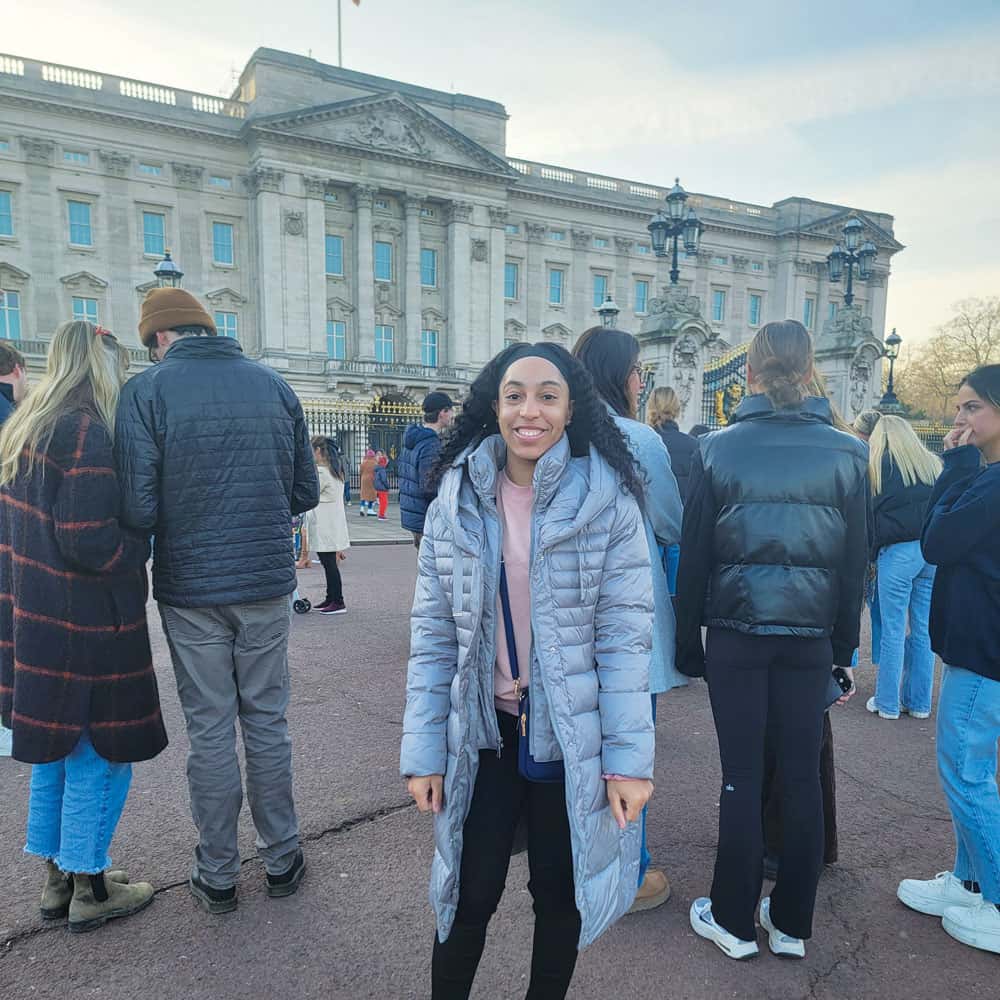 Azaria Boyd poses for a photo with Buckingham Palace in the background