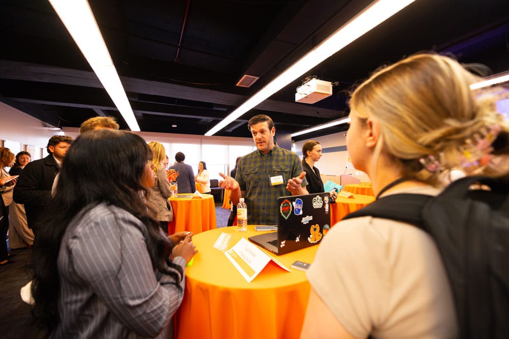 Students talk with alumni professionals during a CCI event