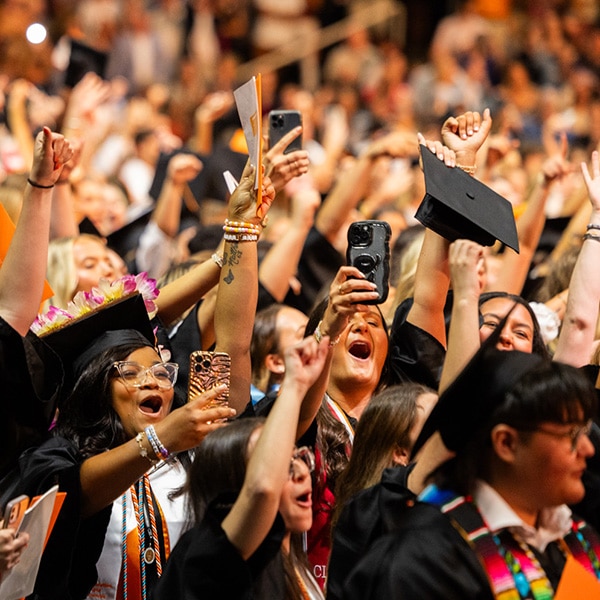 Students cheering during a graduation ceremony