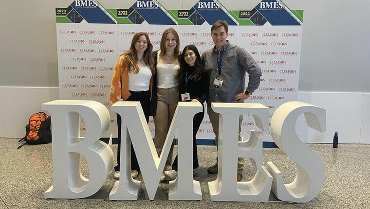 Four students pose with B-M-E-S letters