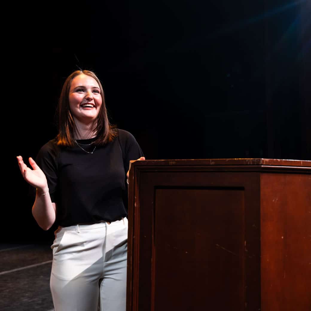 A student stands at a lectern
