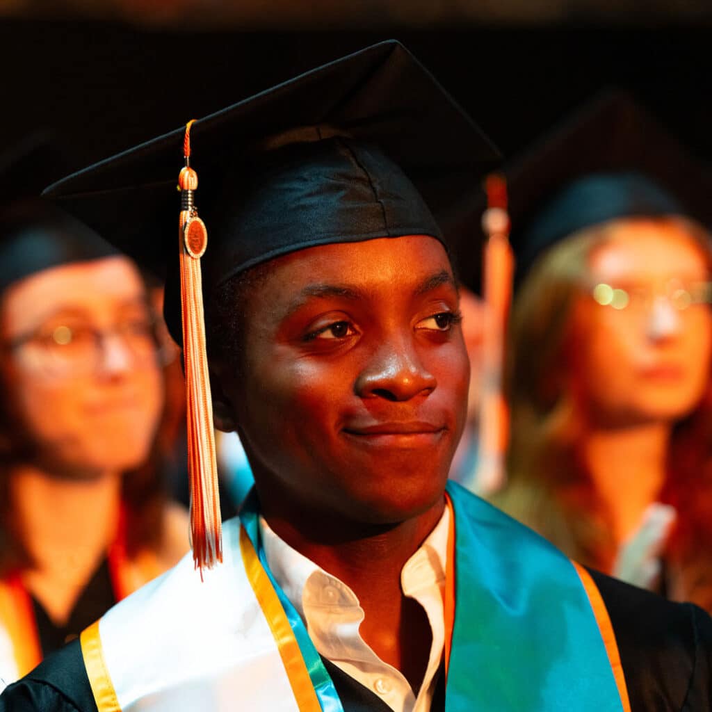 A black graduate in a cap and gown