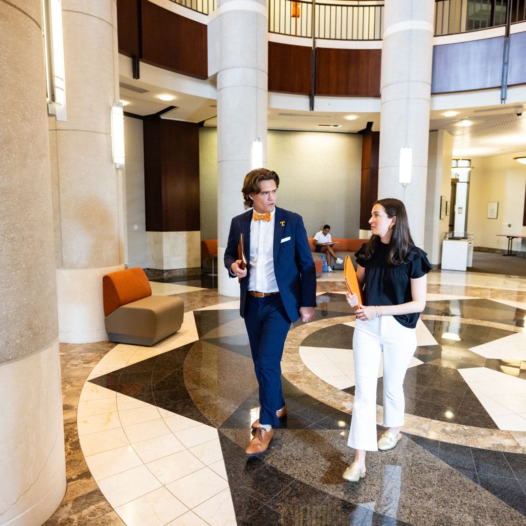 Two students walking in the lobby of the Baker Center