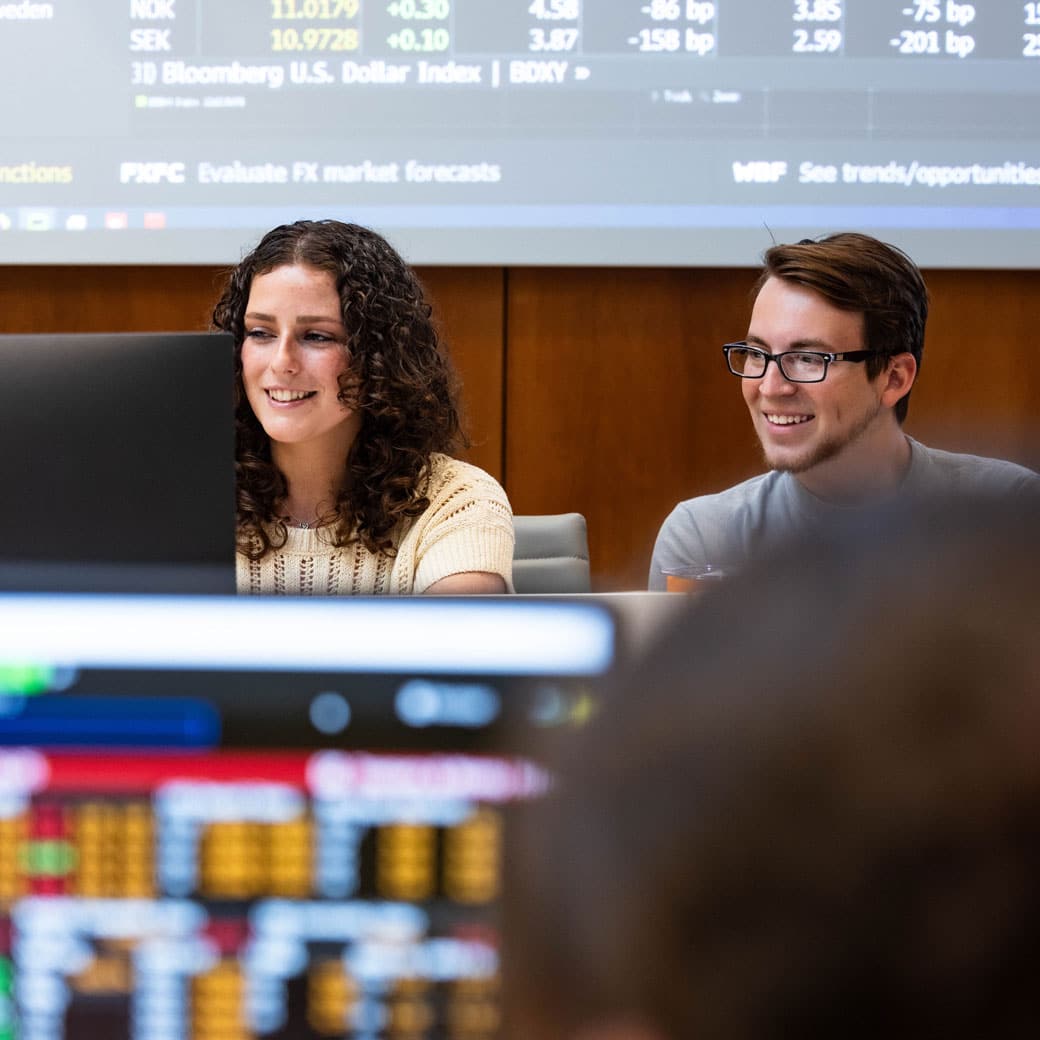 Two students look at a screen in the Master Investment Learning Center