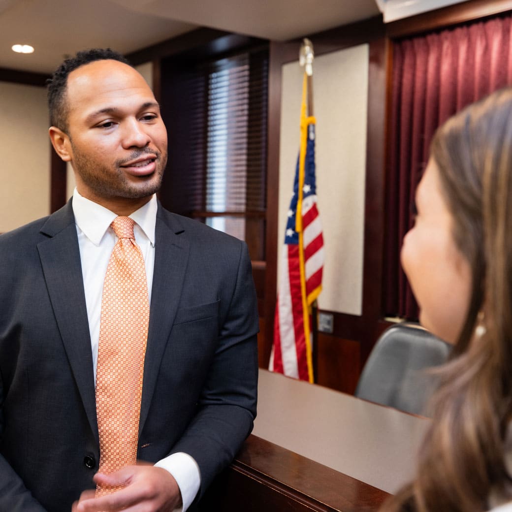 Two people talking in a courtroom