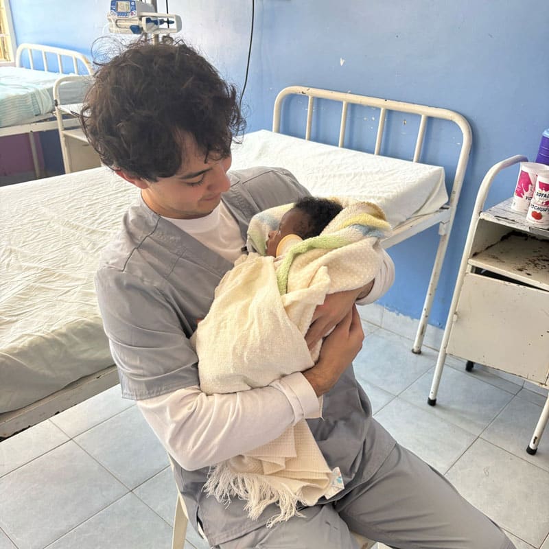 greenberg-oster-in-kenya-800x800-3 Jiro Greenberg-Oster holds a baby.