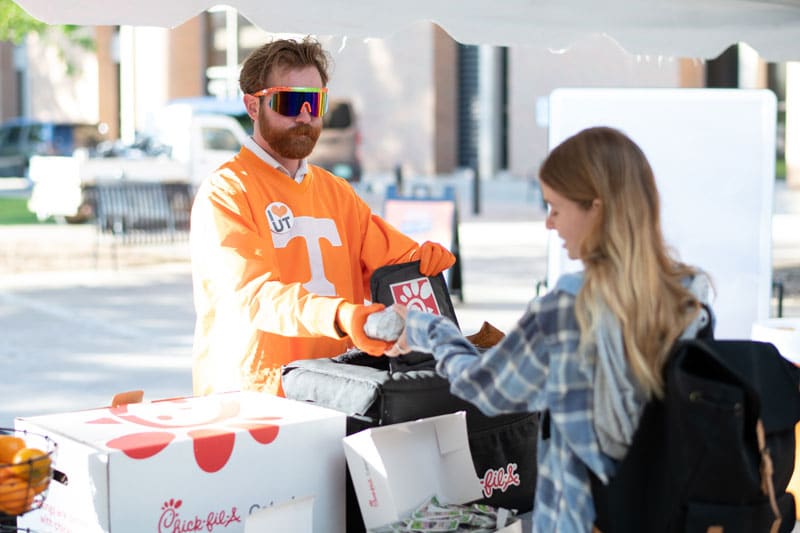 myers-tyler-saa-welcome-wednesday-800x533 Tyler Myers hands a fellow student a Chick-fil-A chicken biscuit as part of the Student Alumni Programs Welcome Wednesday event.