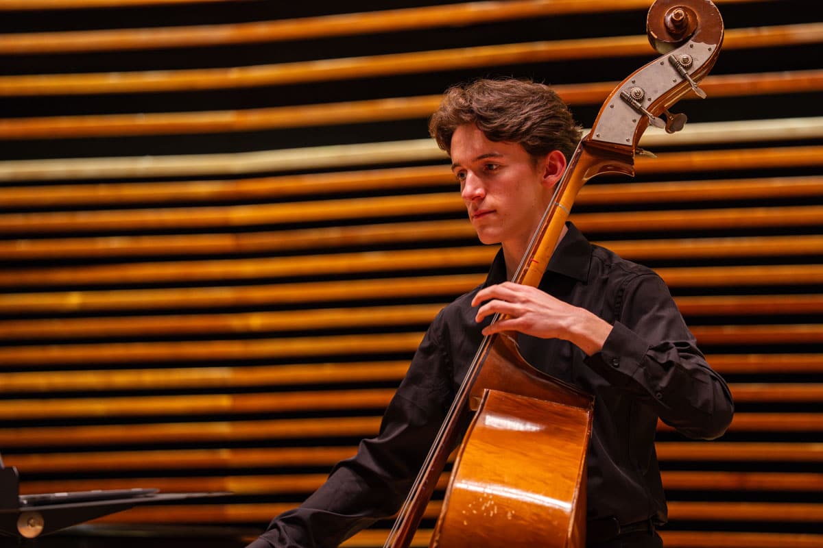string-project-2024-26-ut-student-teachers-1200x800-2 A UT String Project student teacher performs on a cello.