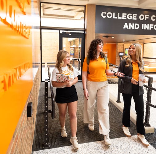fye-2025-gallery-CCI-students Three students walking down the hall in the CCI building.