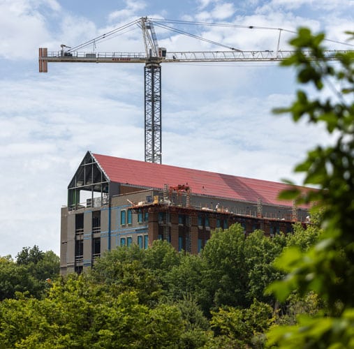 fye-2025-gallery-newnursingbuilding A construction crane rising above the new Nursing building on UT's campus.