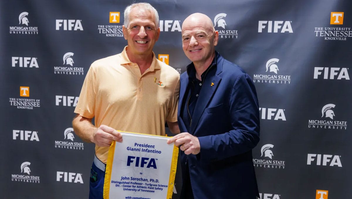 John Sorochan receives a personalized pennant from FIFA President Gianni Infantino.
