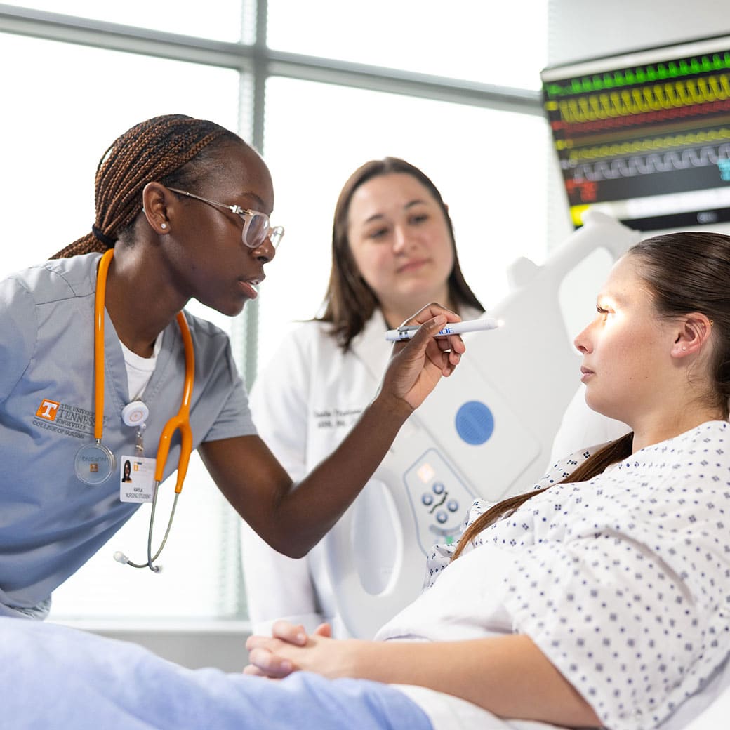 UT medical student looking into a patients eye