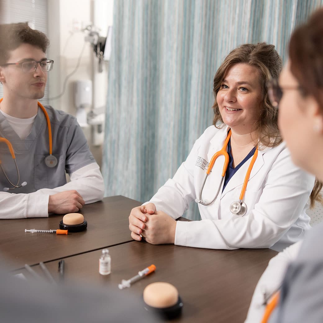 Ut medical doctor and students talking around a table 