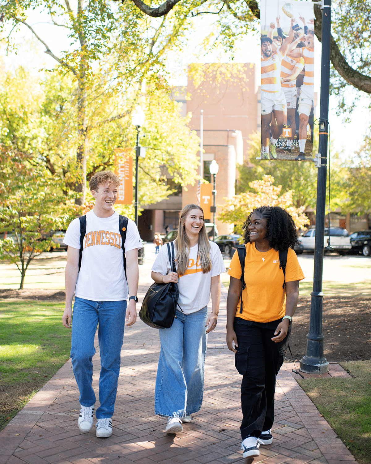 three students walking on the universty of tennessee campus