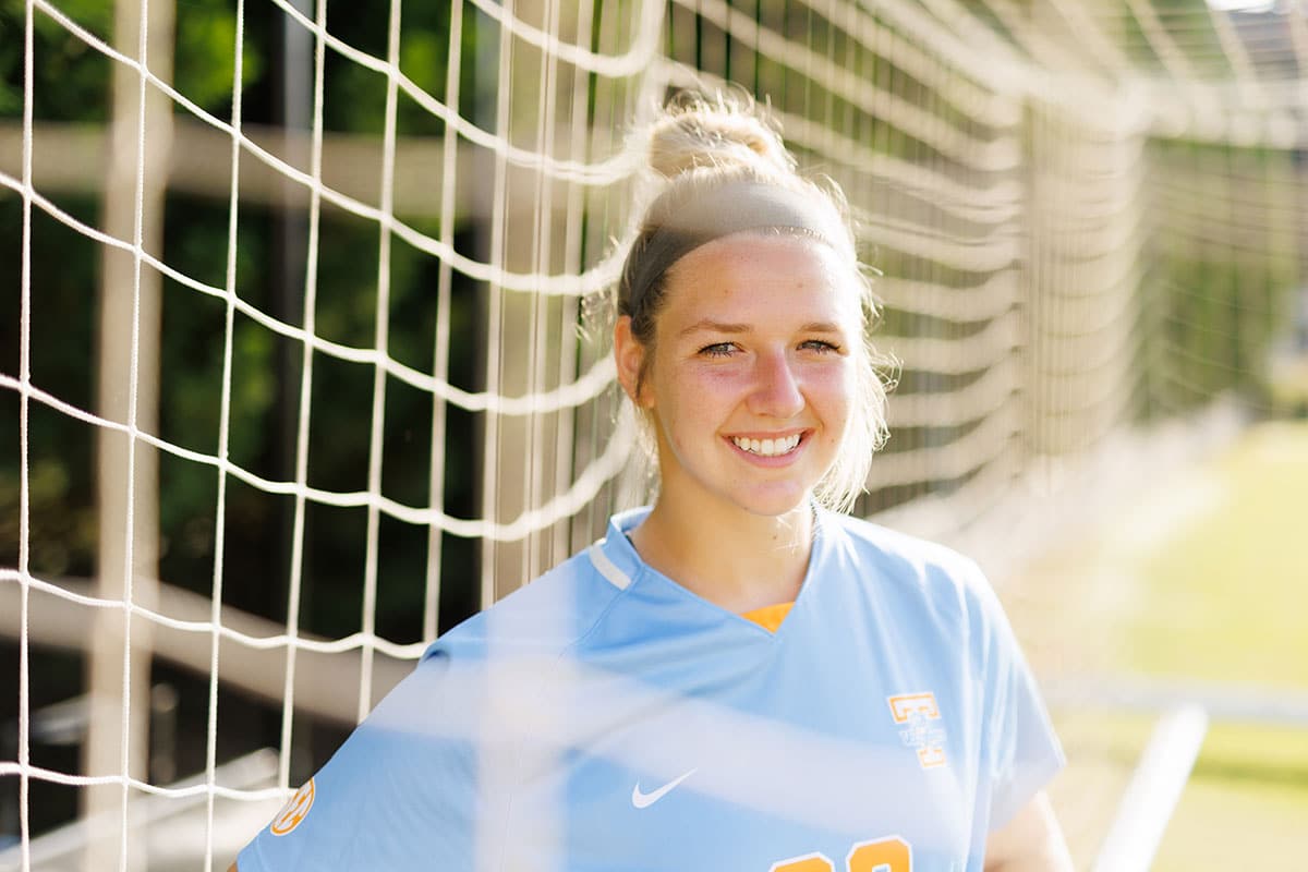 UT soccer player smiling in the goal