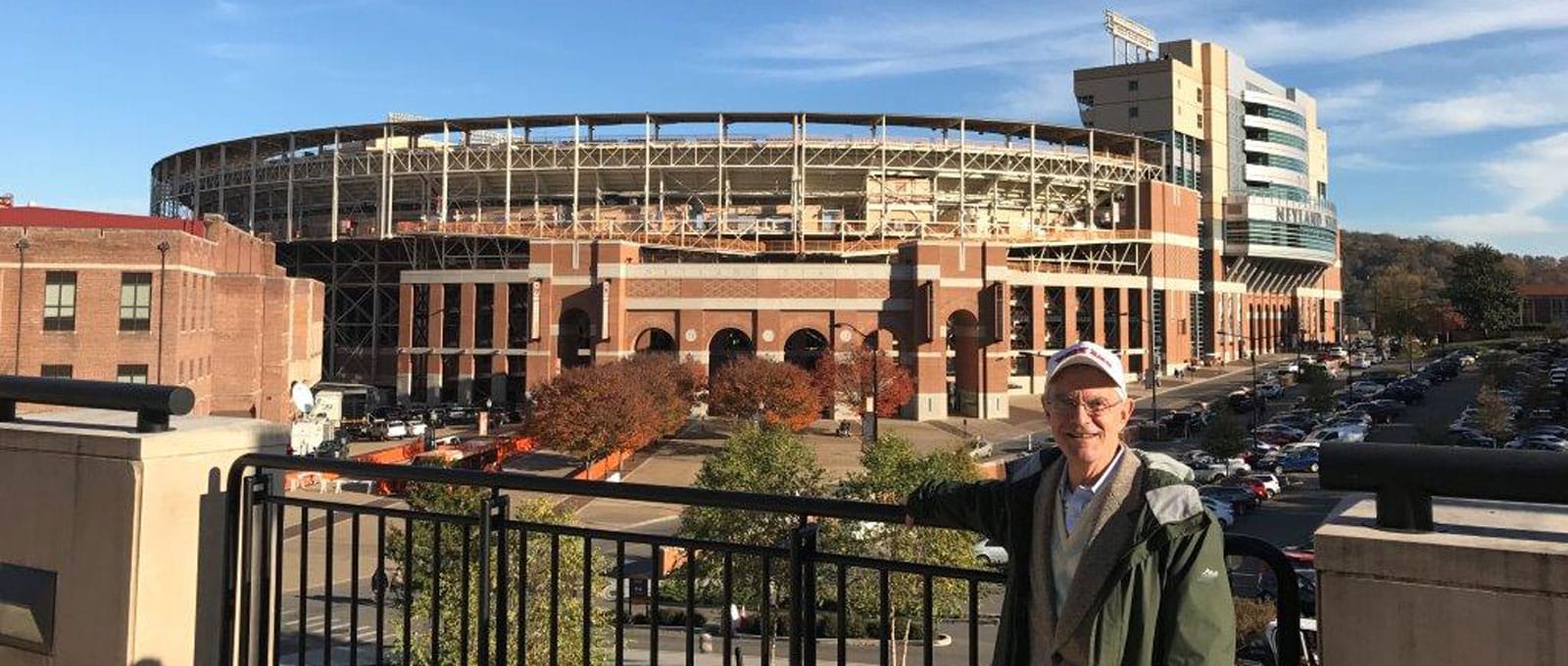 Man posing in front of stadium